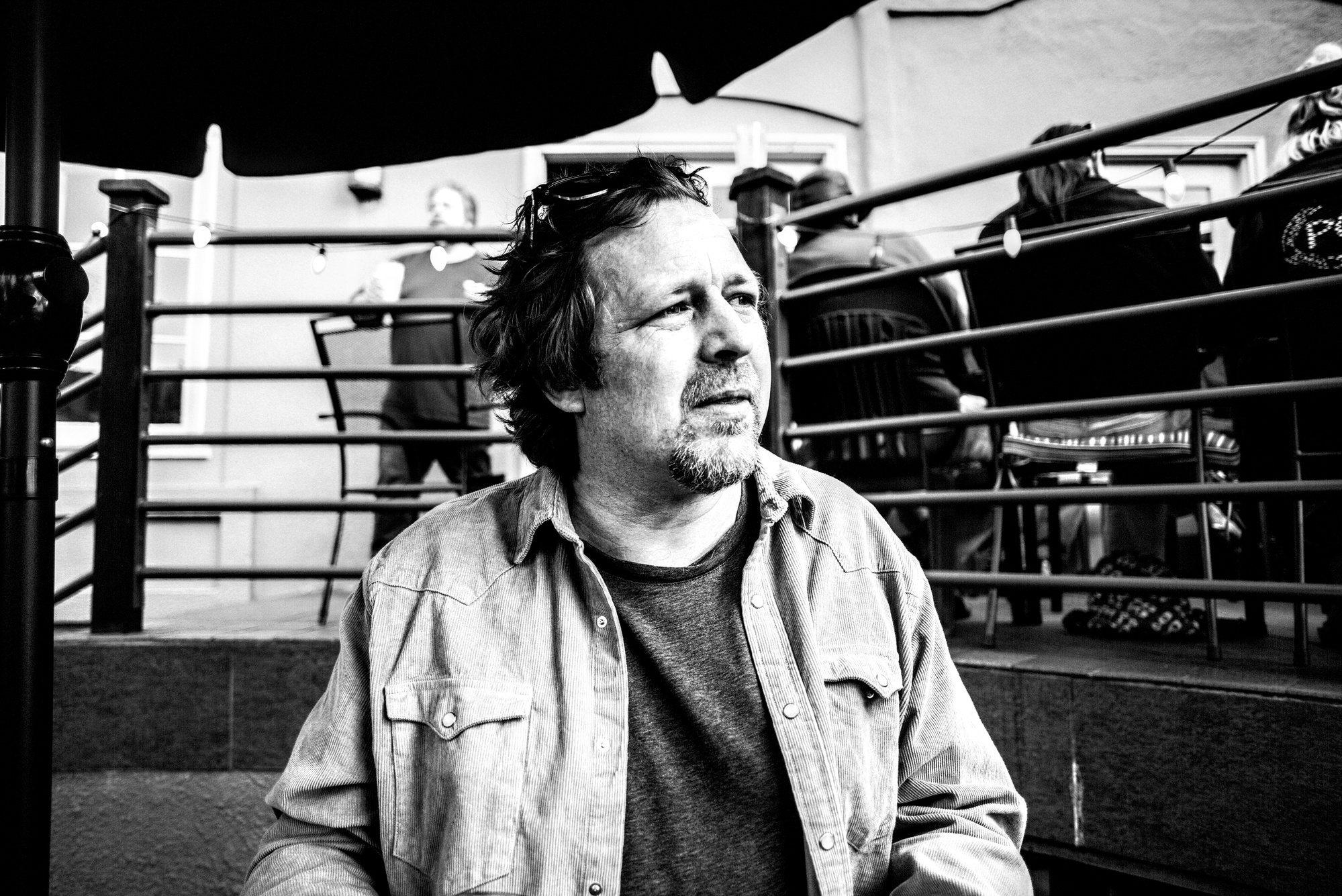 A photo of a man sitting at a pub.