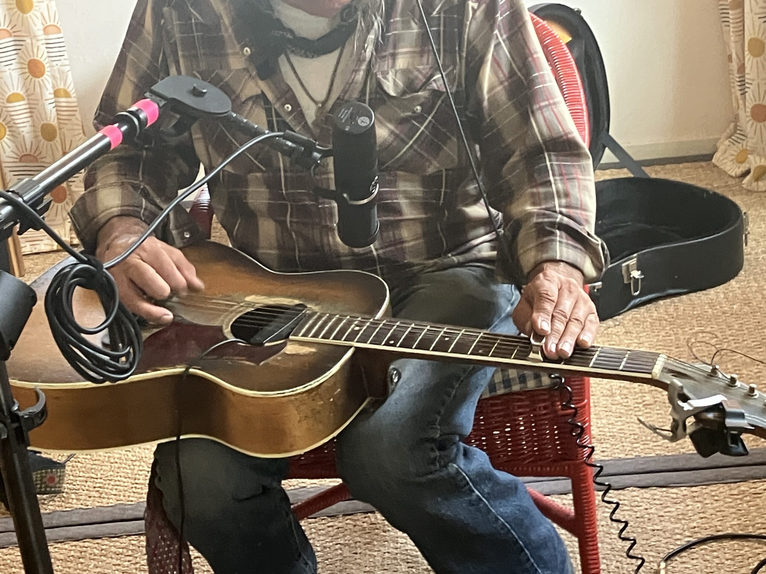 Photo of a man playing slide guitar.