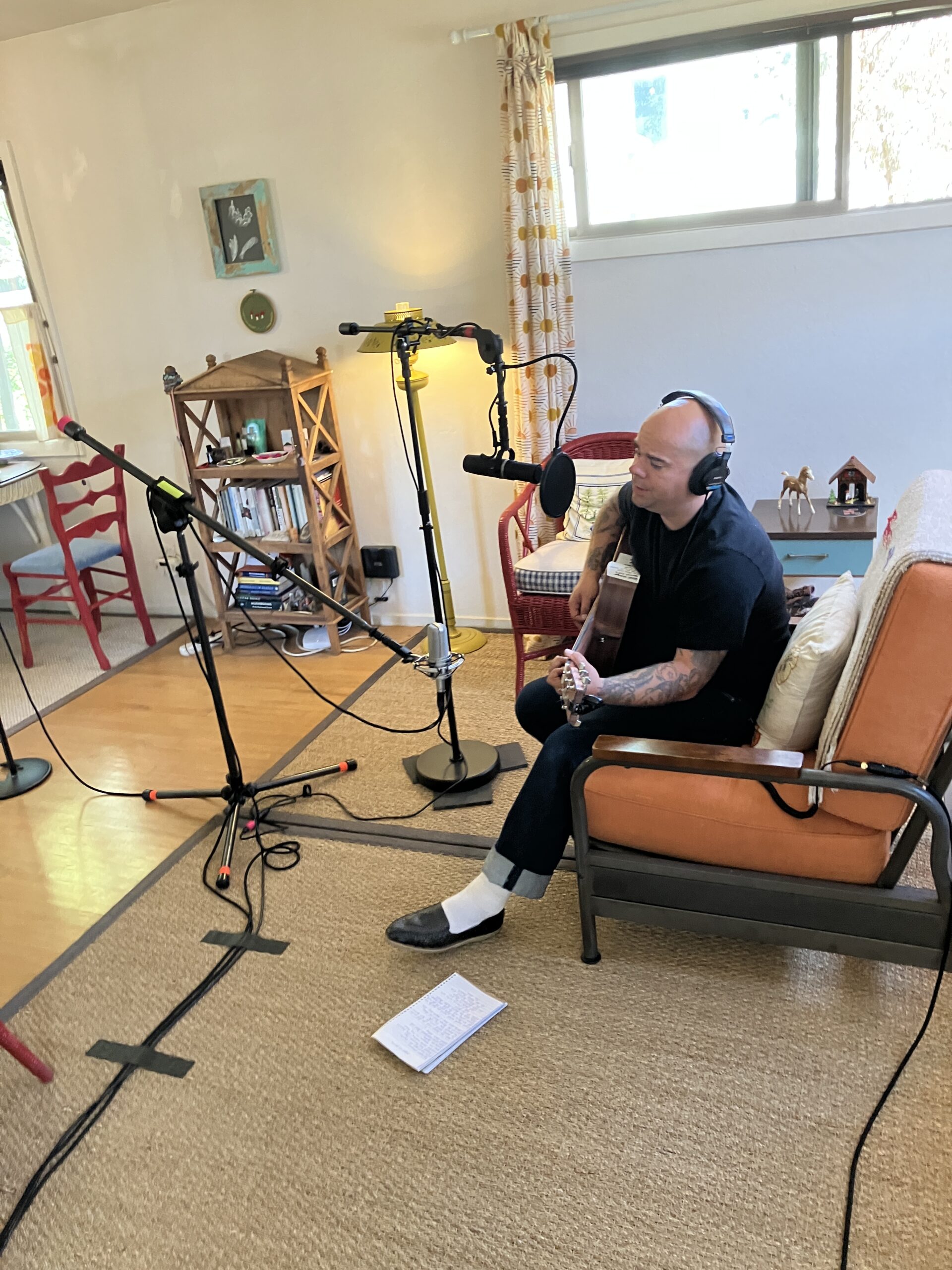 An artist recording in a small home studio.