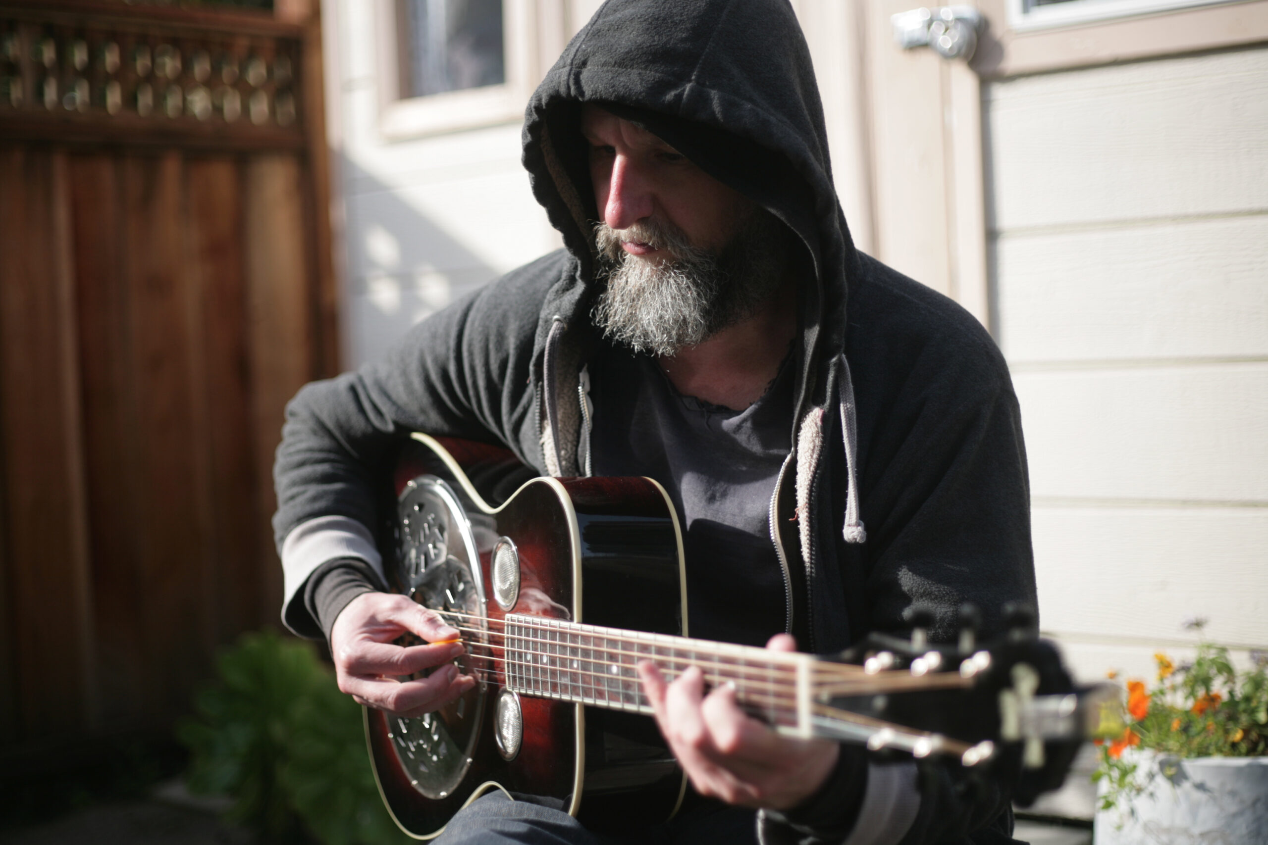 A musician strumming a dobro.