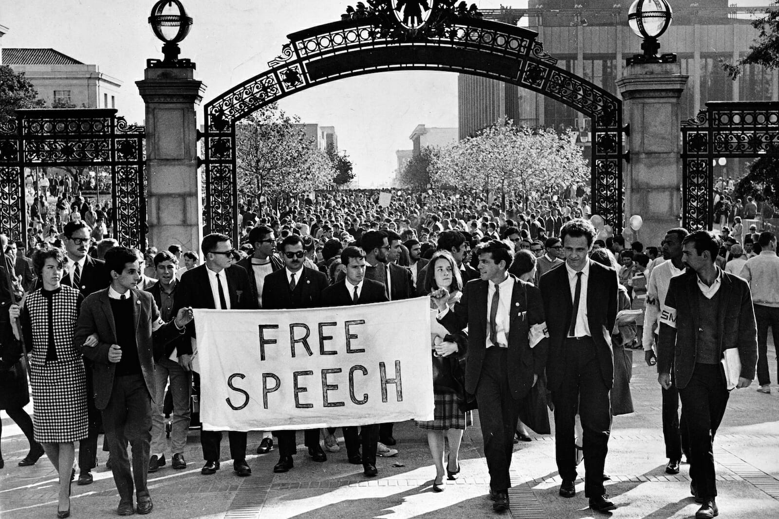 A black and white photo of a free speech movement protest at Sather Gate in Berkeley in the 60s.
